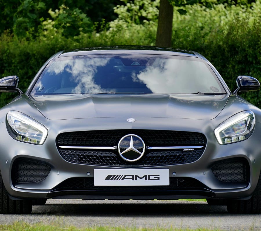Two adults discussing mental health in a counseling session across a glass table indoors.