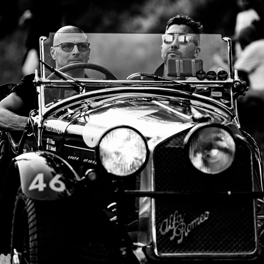 A close-up shot of a hand offering a blue debit card for payment.
